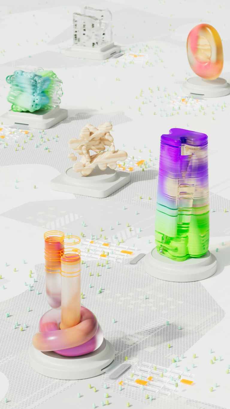 Vibrant 3D abstract sculptures displayed on a pristine white surface under bright lighting.